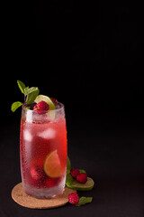 Exotic lemon and blackberry drink with black background