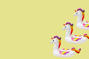 inflatable circle or ring for kids rainbow unicorn for floating in summer vacation isolated on colored background