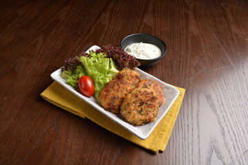chef indian Malay style baked potato cake vegetarian with chef special salad tartar sauce in plate on wood table appetiser western cafe halal asian restaurant menu
