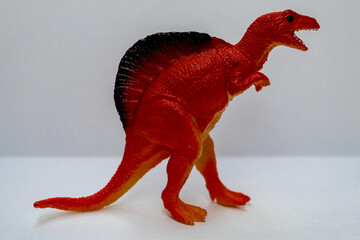 Red dinosaur. Huge and terrifying dinosaur. Kid toy.