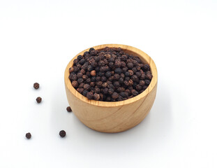 black pepper in a wooden bowl isolated on white background