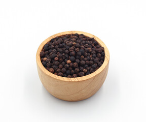 black pepper in a wooden bowl isolated on white background