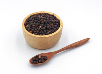black pepper in a wooden bowl isolated on white background