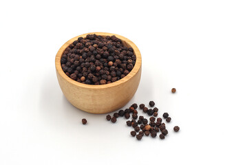 black pepper in a wooden bowl isolated on white background