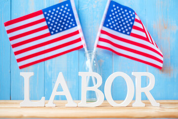 LABOR text and United States of America flag on wooden table background. happy Labor day and holiday celebration concepts