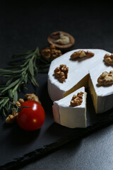 Still life with cheese on a dark background