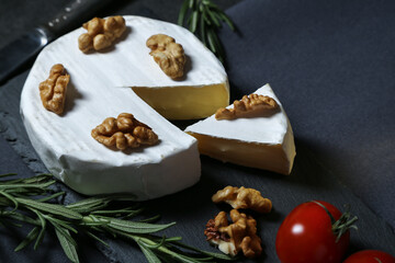 Still life with cheese on a dark background