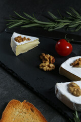 Still life with cheese on a dark background
