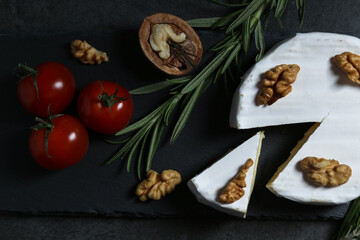Still life with cheese on a dark background