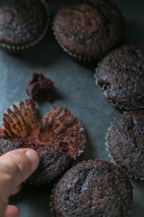 Delicious and fresh chocolate muffins on a gray ceramic table.