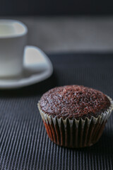 Delicious and fresh chocolate muffins on a gray ceramic table.