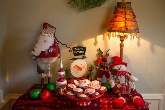 Detail of dining room table decorated for festive Christmas party with cookies and decorations