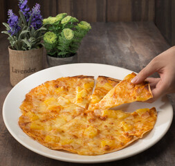  Fast food. Hawaii Chicken Pizza. Western Food. Pizza. Pineapple. Cheese. Chicken. Close up of pizza. Lady hand take a piece of pizza. Café or restaurant background. Dinner or lunch.