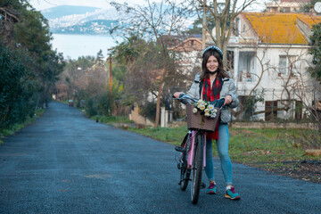 Girl holding a bicycle