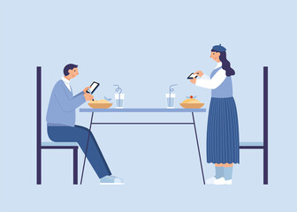 Couple using phones at dining table