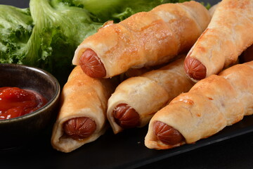 Sausage buns. Soft baked bun (dough )stuffed with pork sausage for fast food breakfast or coffee break. Sausage  roll, (hot dog).