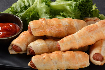 Sausage buns. Soft baked bun (dough )stuffed with pork sausage for fast food breakfast or coffee break. Sausage  roll, (hot dog).