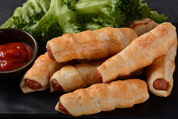 Sausage buns. Soft baked bun (dough )stuffed with pork sausage for fast food breakfast or coffee break. Sausage  roll, (hot dog).