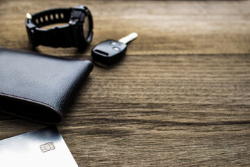 Close up wallet Credit Cards watch and car key on the old wood floor Holiday concept Travel Accessories for texture