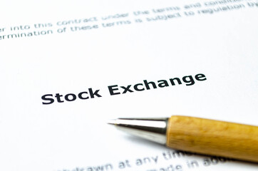 Words stock exchange with wooden pen