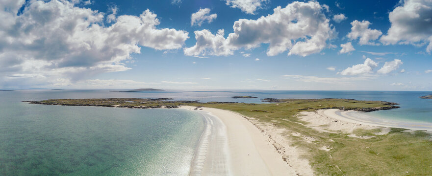 Aerial view on Gurteen bay and beach, county Galway, Ireland. Long stretch of sandy beach and beautiful ocean. Irish landscape. Warm sunny day, cloudy sky. Panorama image