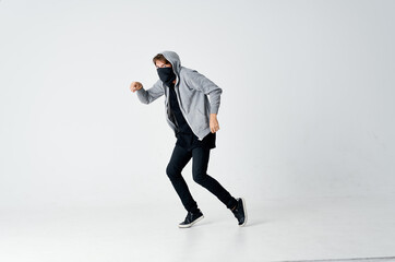 man thief hides his face anonymity crime caution