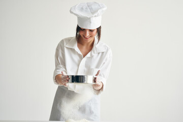 woman baker in chef's clothes professional working with dough kitchen