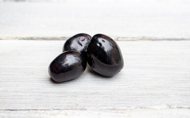Closeup of Organic Jamun or Black Plum Isolated on Wooden Background, Also Known as Malabar Plum or Jambola