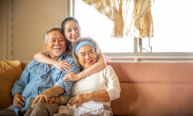 Daughter hugs father and mother showing love in the living room, happy family. - Powered by Adobe