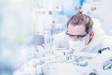 Engineering scientist working with advanced technology medical device in science laboratory for...