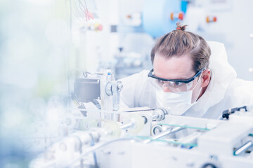 Engineering scientist working with advanced technology medical device in science laboratory for experimental research.