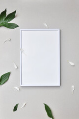 White frame and flower petals side by side. Place the label in the frame. Mockup