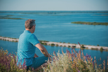 Mature European man with philosophical mood at nature. The concept of life after 50 years, problems...