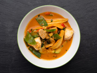 Spicy Red Thai Curry with Chicken and Vegetables in a Bowl, Top View
