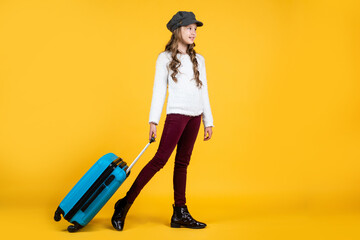 happy kid in cap with travel bag suitcase, traveling