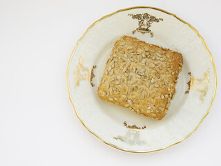 Sunflower bun on porcelain decorated plate on white background