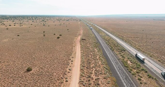 Aerial view highway with of long lane road through desert landscape towards near San Jon New Mexico USA