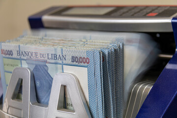 Lebanese Lira Currency being counted by a money counting machine