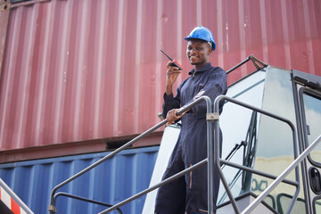 Container Worker hold Walkie Talkie on his Hand on the Cargo Crane Llifting Truck