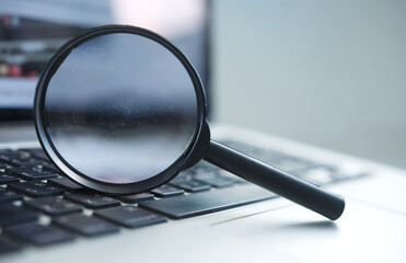 Search concept.magnifying glass on laptop.