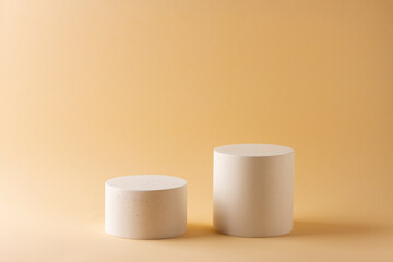 Composition with concrete cylinders in the style of minimalism on delicate background