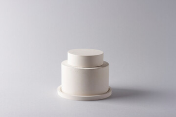 Composition with concrete cylinders in the style of minimalism on delicate background