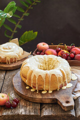Buns with peaches and white chocolate. Fruits, coffee, wooden background, side view.