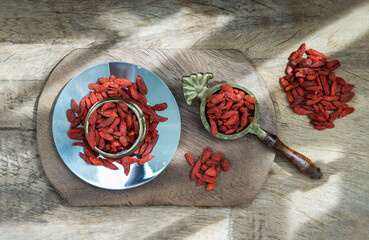 Red goji Berries (dried) on the rustic style old table. Top view, Selective focus.