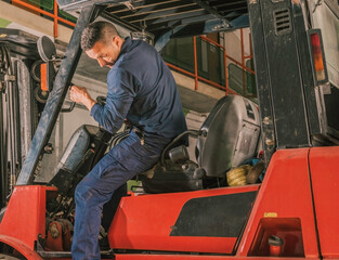 Young Latino man getting off a forklift. © Pepe Quilez
