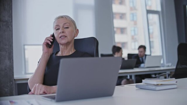 Strict boss catching female employee chatting on phone, procrastination at work