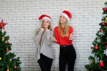 Caucasian girls friends is dancing with funny and happy in Christmas and celebrating new year party. Lifestyle of Lesbian on holiday Concept