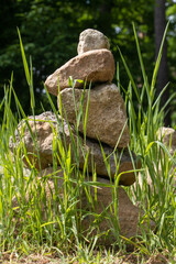 Stones balanced into a tower in a meadow