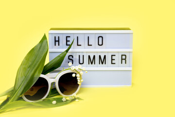 Lightbox with message Hello Summer on yellow background. Concept of summer,travel,vacation