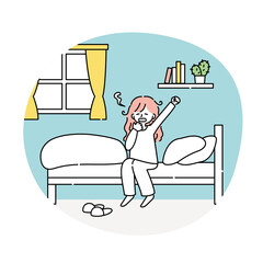朝起きてベッドの上であくびをする女性